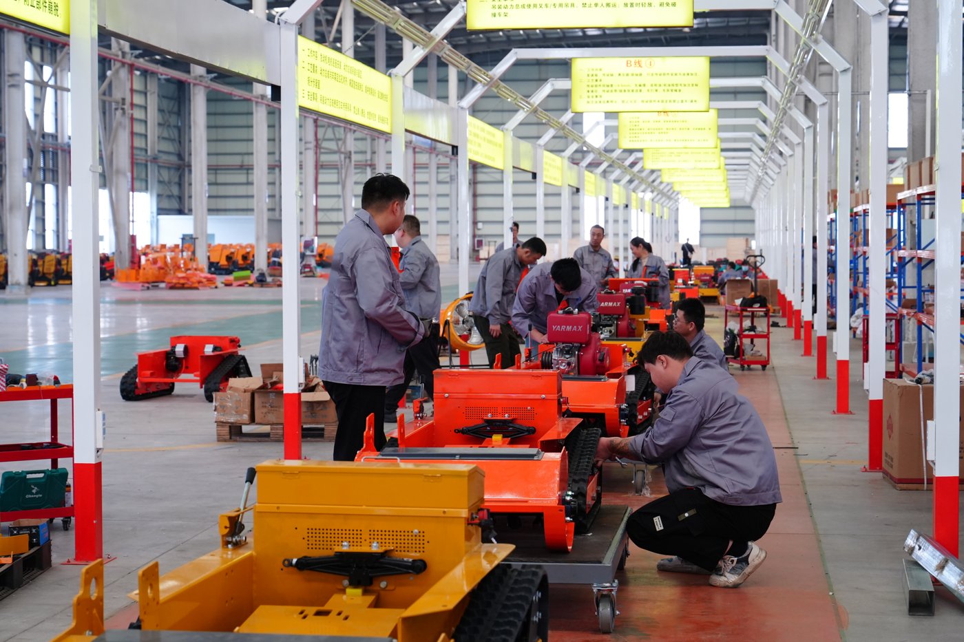 Workers assembling remote control mowers on the production line